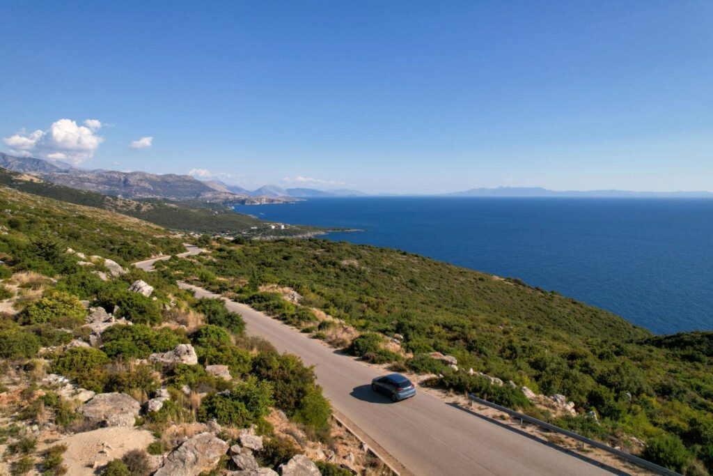 SUV driving along Albanian Riviera coastal road