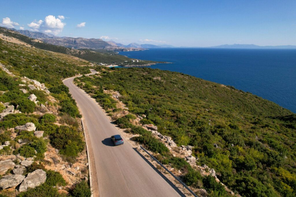 SUV driving along Albanian Riviera coastal road